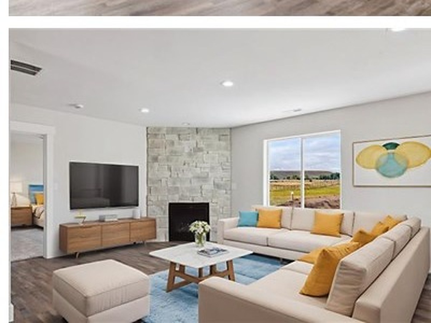 Staged living room with stone fireplace at Meadows, Fort Bridger